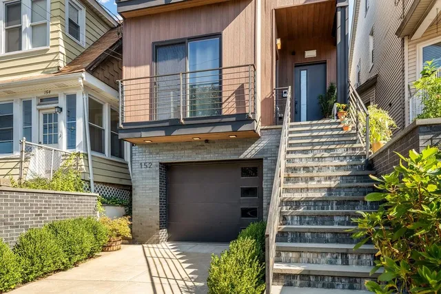 a front view of a house with a garden