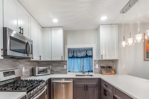 a kitchen with a sink stove and microwave