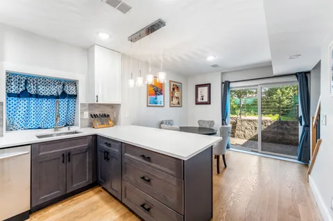 a kitchen with a sink stove and cabinets