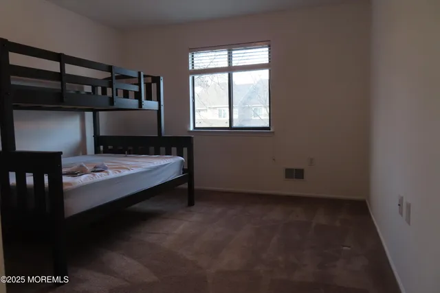 a bed room with a bed and a window