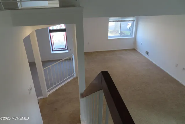 view of room with window and stairs