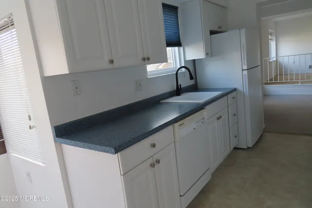 a kitchen with a sink and cabinets