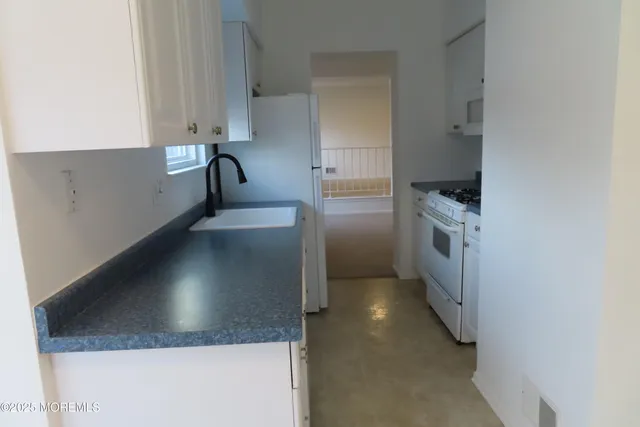 a kitchen with a sink and a stove