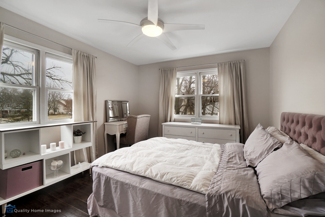 603 Raintree Road Buffalo Grove, IL 60089 - Photo 14 of 20 a bedroom with a bed dresser and a window