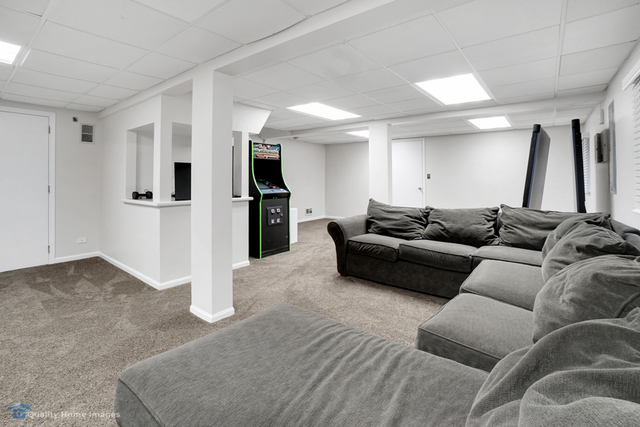 603 Raintree Road Buffalo Grove, IL 60089 - Photo 17 of 20 a living room with furniture and a refrigerator