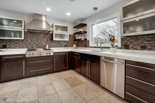 603 Raintree Road Buffalo Grove, IL 60089 - Photo 4 of 20 a kitchen with a sink stove and cabinets