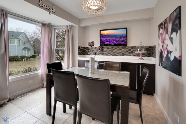 603 Raintree Road Buffalo Grove, IL 60089 - Photo 5 of 20 a view of a dining room with furniture window and outside view