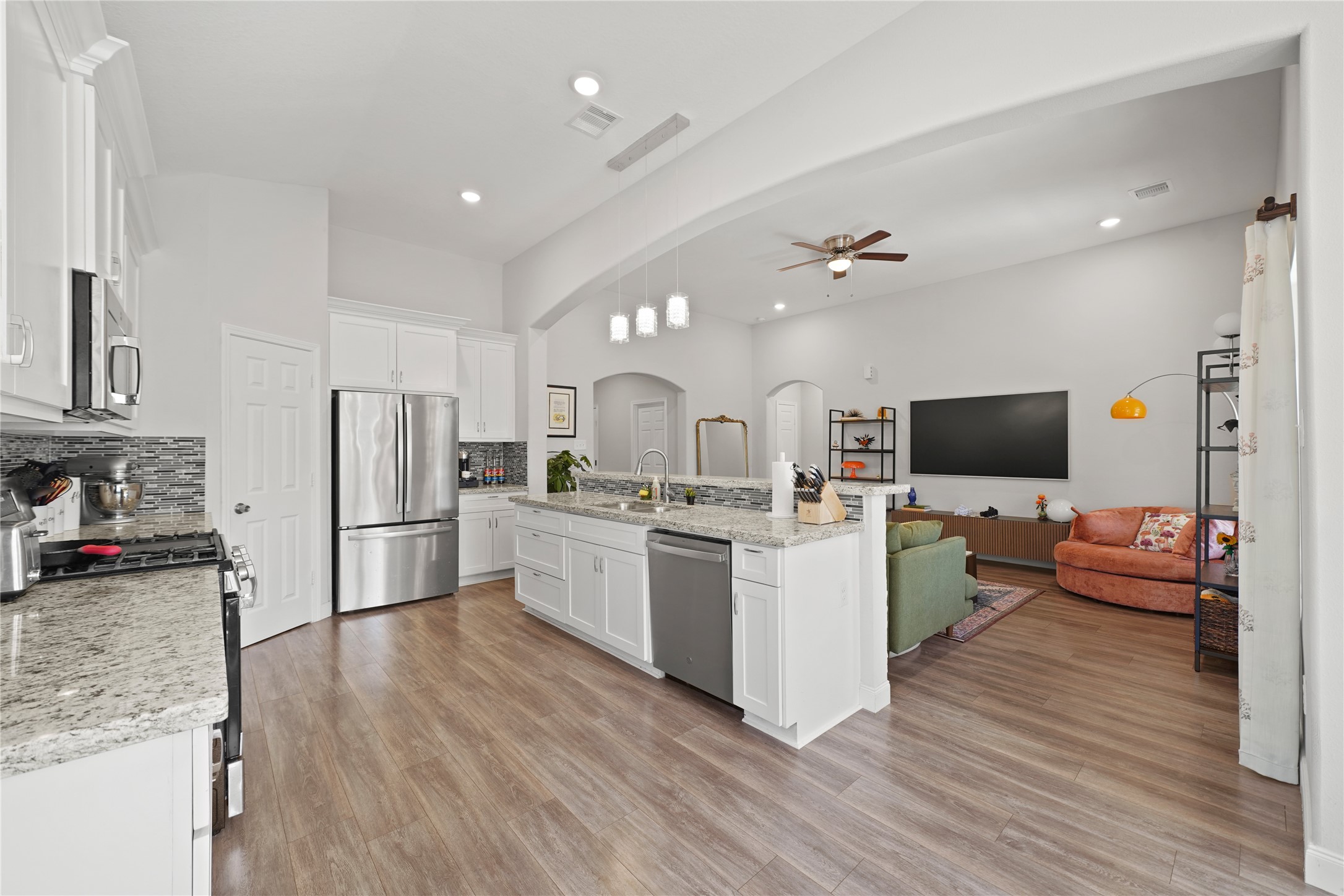 5602 Belmark Street Houston, TX 77033 - Photo 13 of 27 a kitchen with stainless steel appliances kitchen island a refrigerator sink and stove