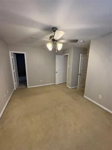 a view of an empty room with a ceiling fan
