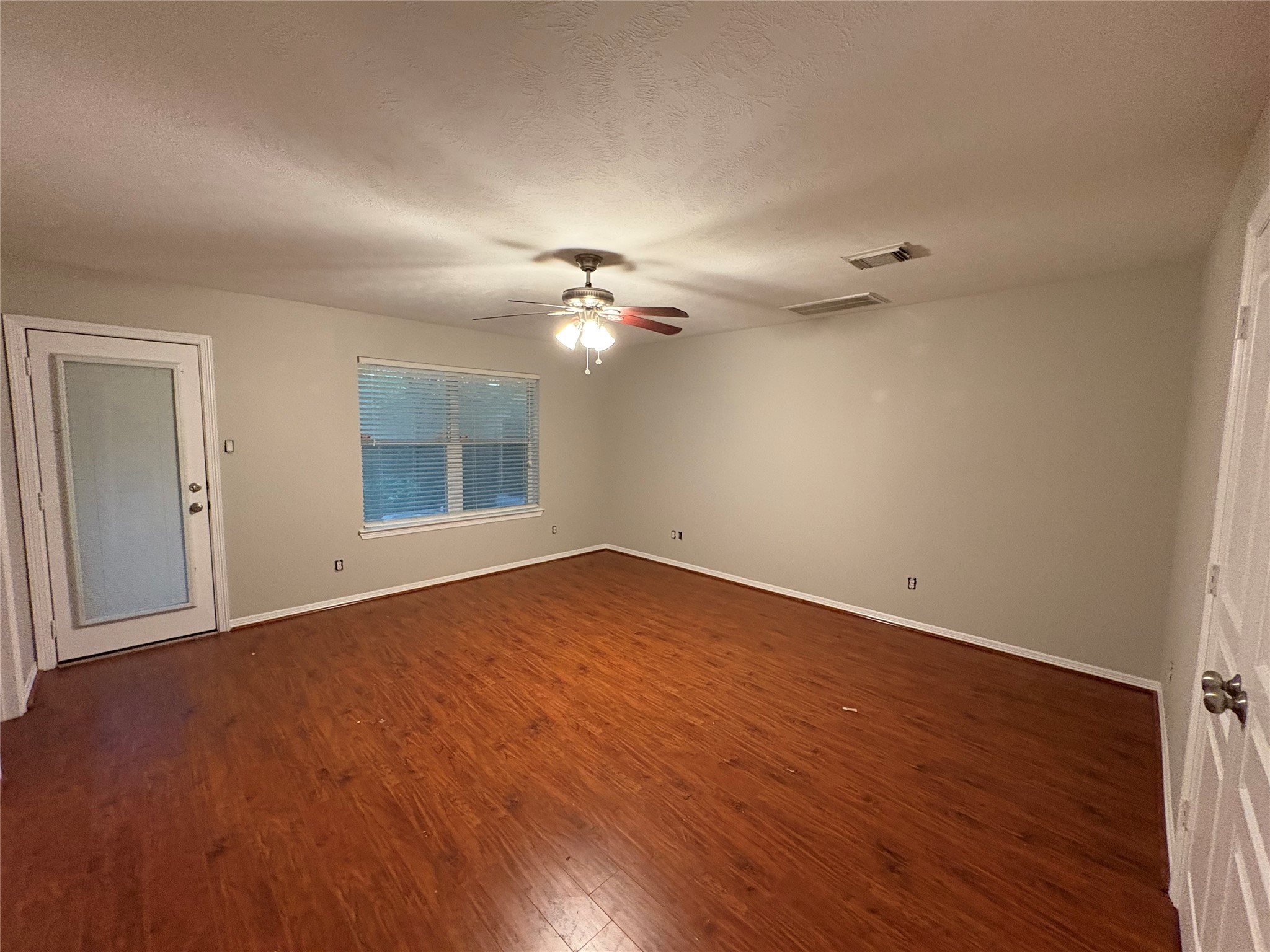 2614 Enclave At Shady Acres Court Houston, TX 77008 - Photo 2 of 15 wooden floor in an empty room with a window