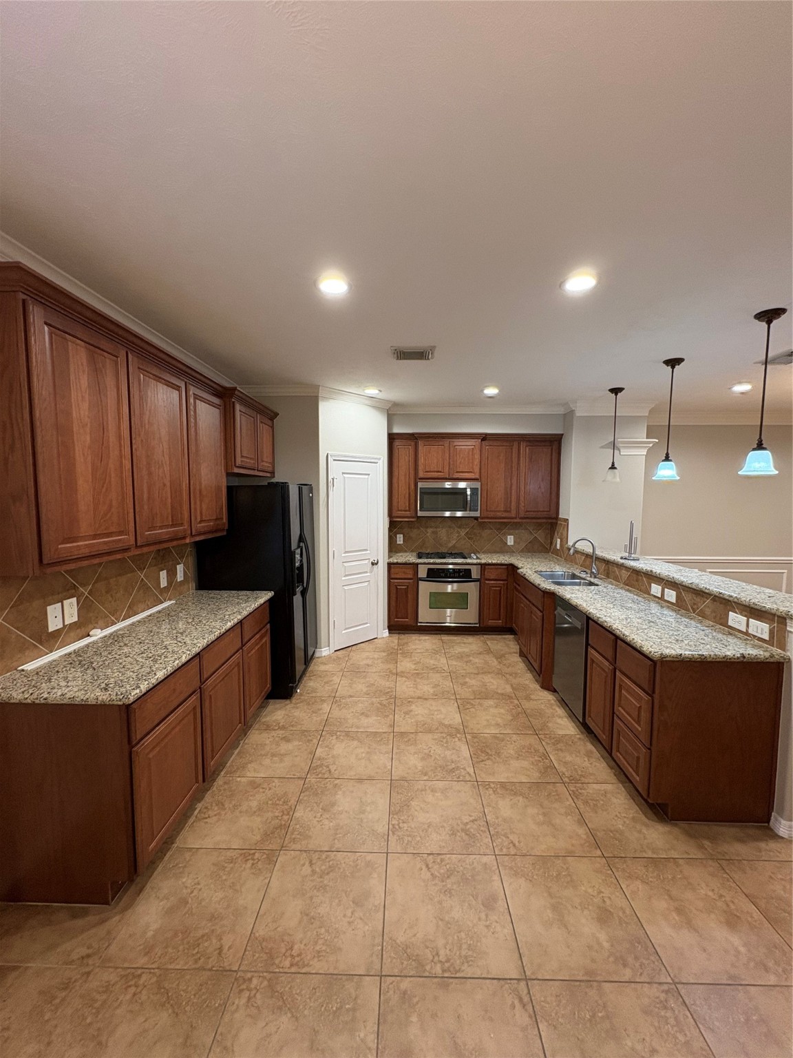 2614 Enclave At Shady Acres Court Houston, TX 77008 - Photo 3 of 15 a large kitchen with stainless steel appliances lots of counter top space