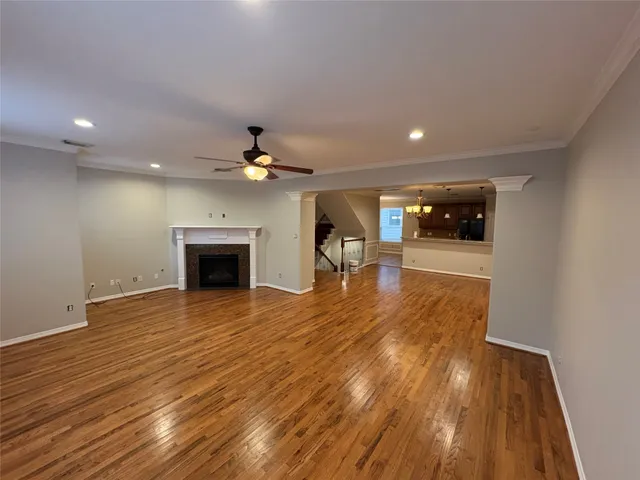 an empty room with wooden floor and fireplace