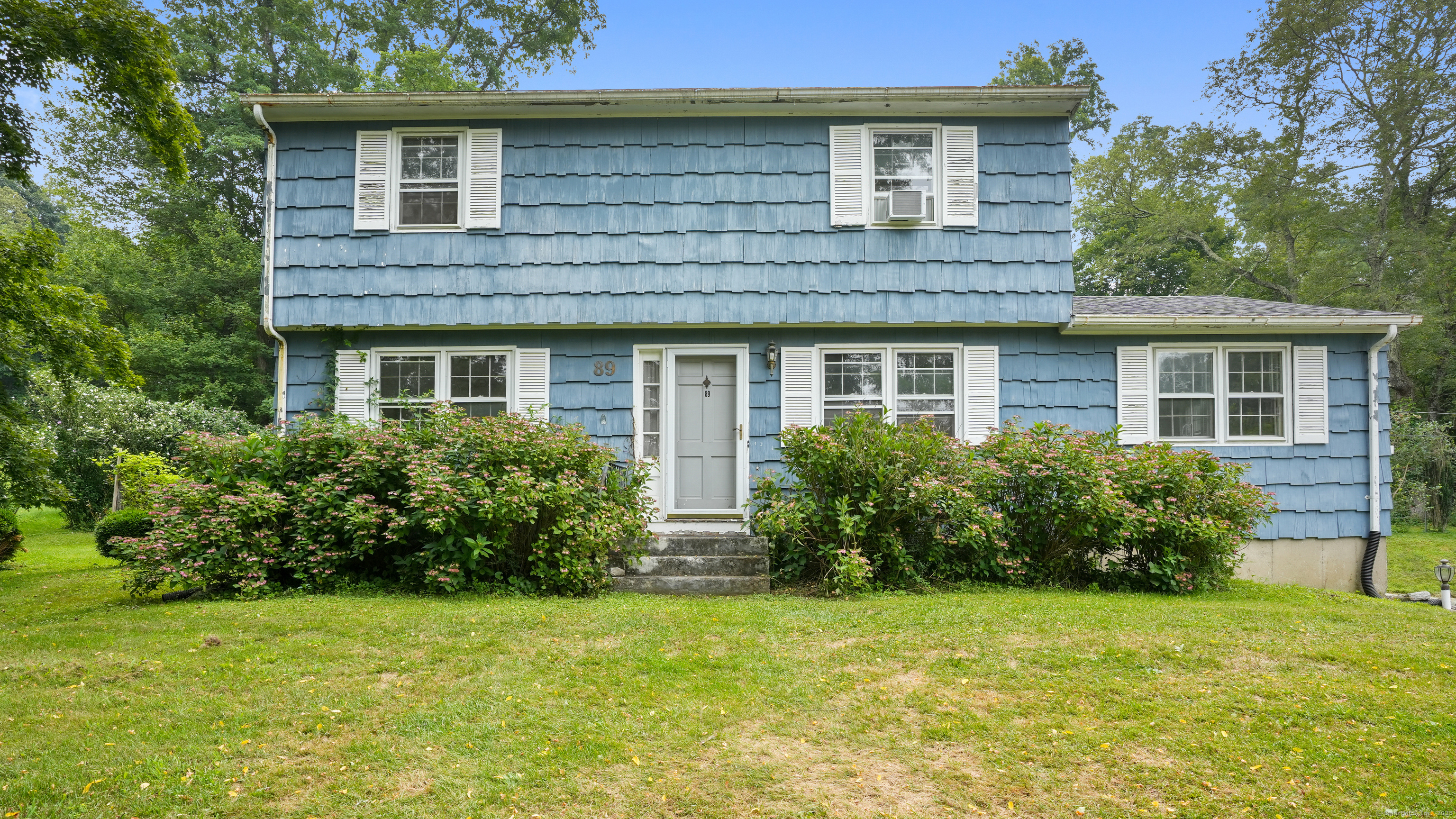 89 Birch Hill Road Newtown, CT 06470 - Photo 1 of 1 a front view of a house with garden