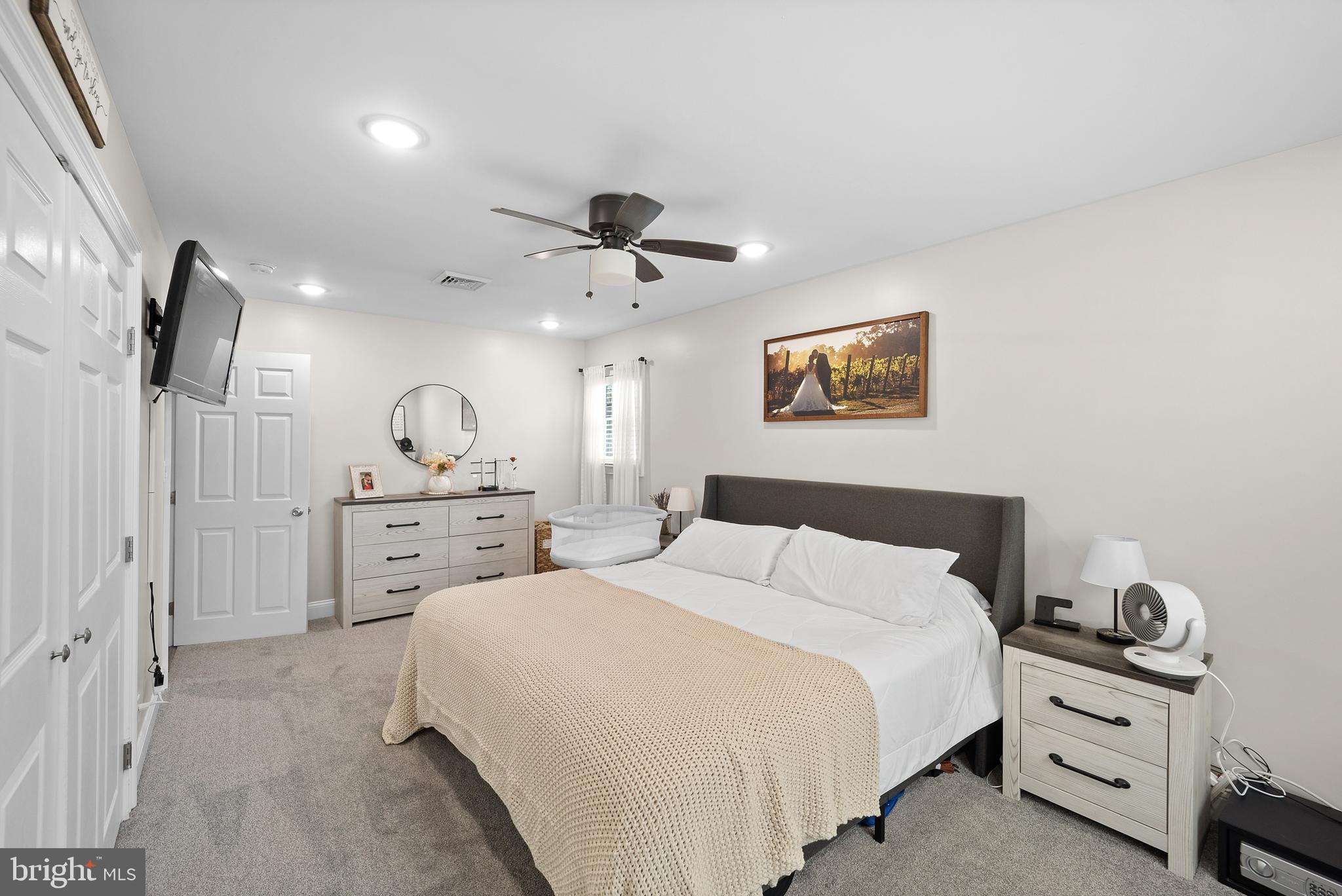 837 Fairfield Road Fairless Hills, PA 19030 - Photo 11 of 31 a spacious bedroom with a bed and a chandelier