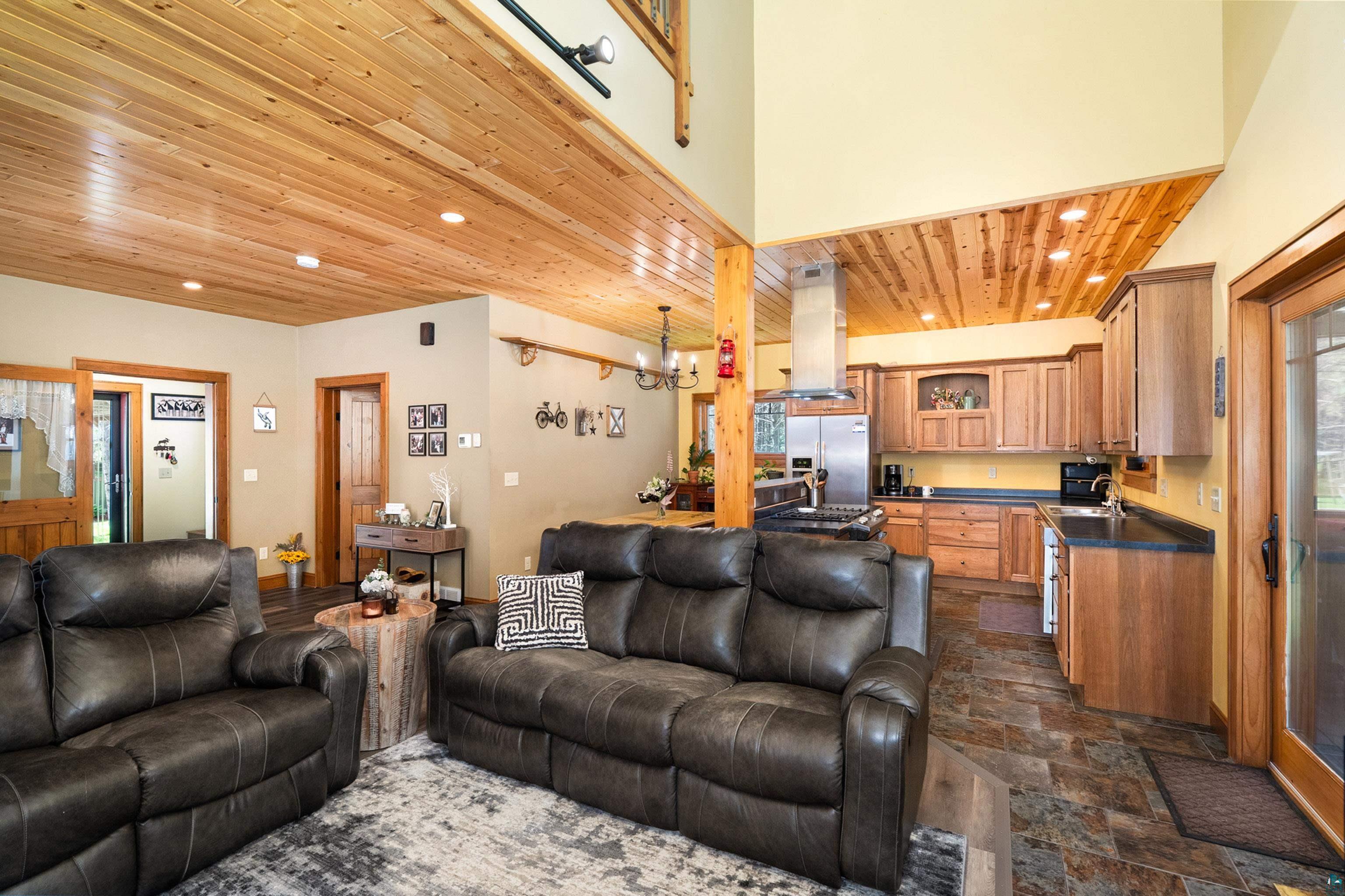 75 East Stark Road Esko, MN 55733 - Photo 14 of 87 Open-concept living space featuring wood-plank ceilings with recessed lighting, an exposed wood support beam, and durable tile flooring