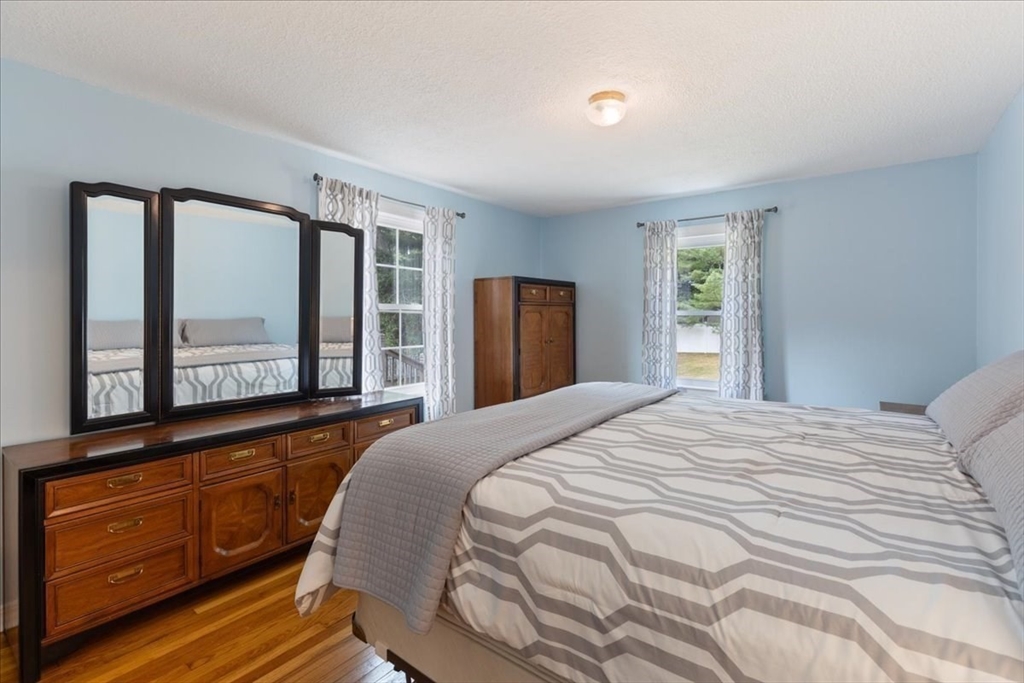12 Bay Path Kingston, MA 02364 - Photo 13 of 24 a bedroom with a bed and window with chair