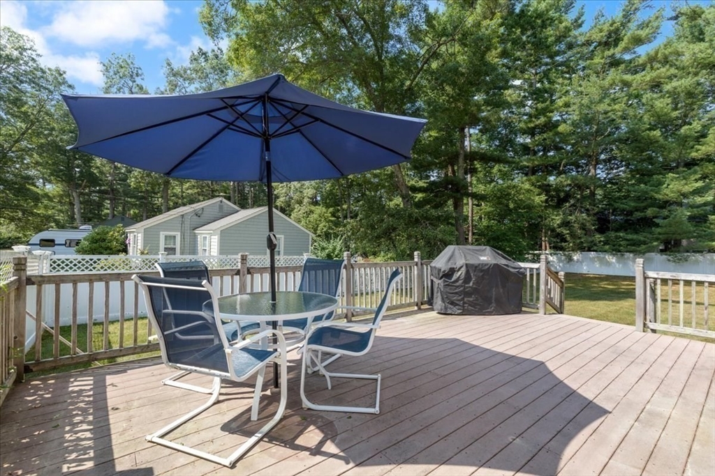 12 Bay Path Kingston, MA 02364 - Photo 22 of 24 a view of a patio with wooden floor a yard a table and chairs