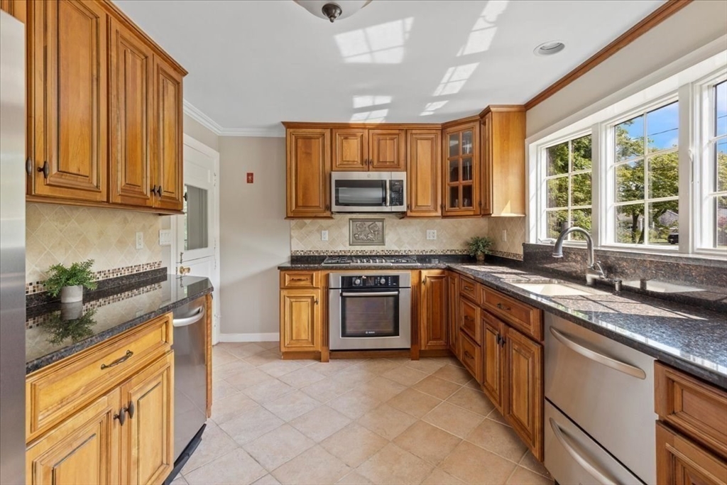12 Bay Path Kingston, MA 02364 - Photo 5 of 24 a kitchen with stainless steel appliances granite countertop a stove sink and cabinets