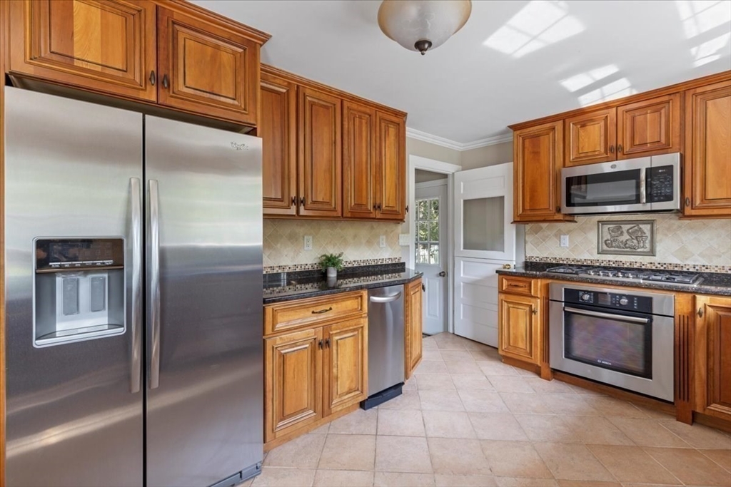 12 Bay Path Kingston, MA 02364 - Photo 8 of 24 a kitchen with stainless steel appliances granite countertop a refrigerator stove top oven a sink and dishwasher