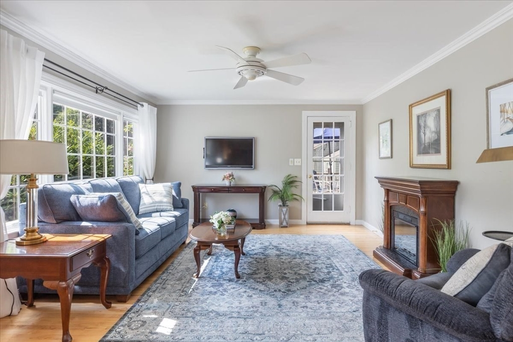 12 Bay Path Kingston, MA 02364 - Photo 9 of 24 a living room with furniture a fireplace and a flat screen tv