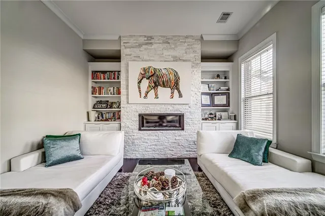 a living room with furniture and a fireplace