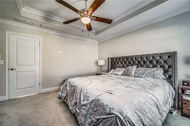 a bedroom with a bed and a ceiling fan