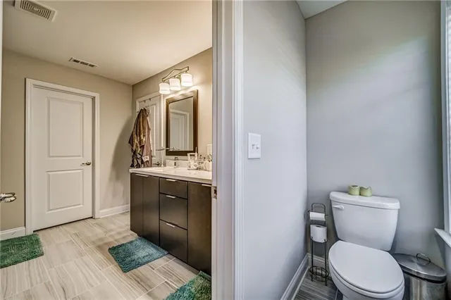 a bathroom with a toilet a sink and mirror