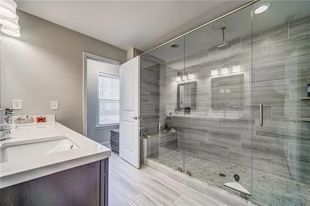 a bathroom with a shower and a sink