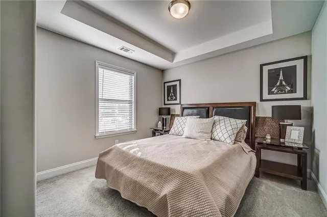 a bedroom with a large bed and a night stand