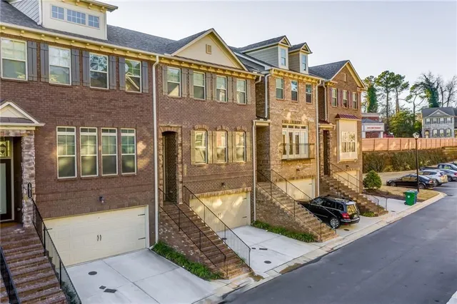 a view of a brick house with many windows