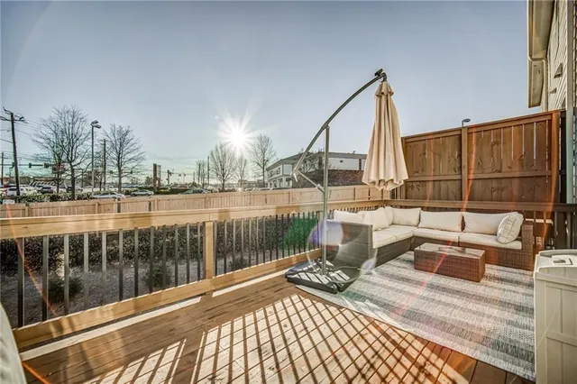 a view of a balcony with couch and wooden floor