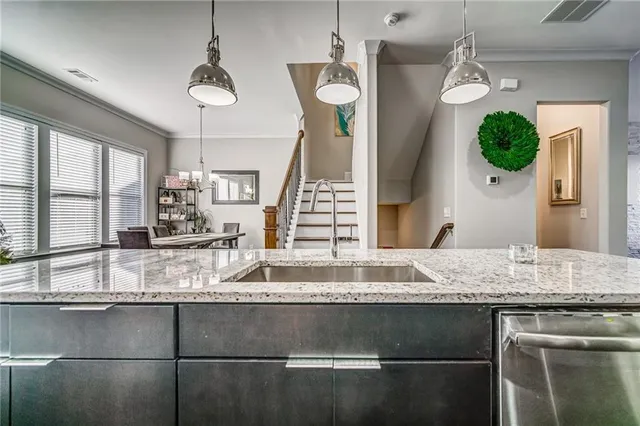 a bathroom with a granite countertop sink and a window