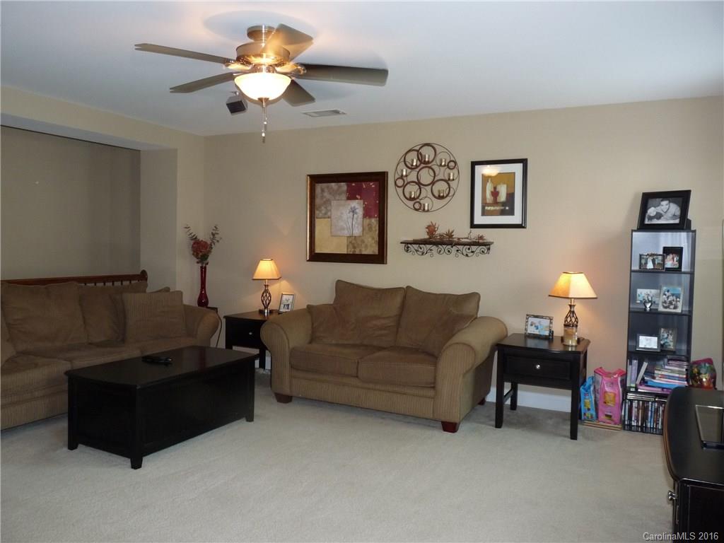 221 River Clay Road, Unit 183 Fort Mill, SC 29708 - Photo 11 of 20 a living room with furniture and a lamp