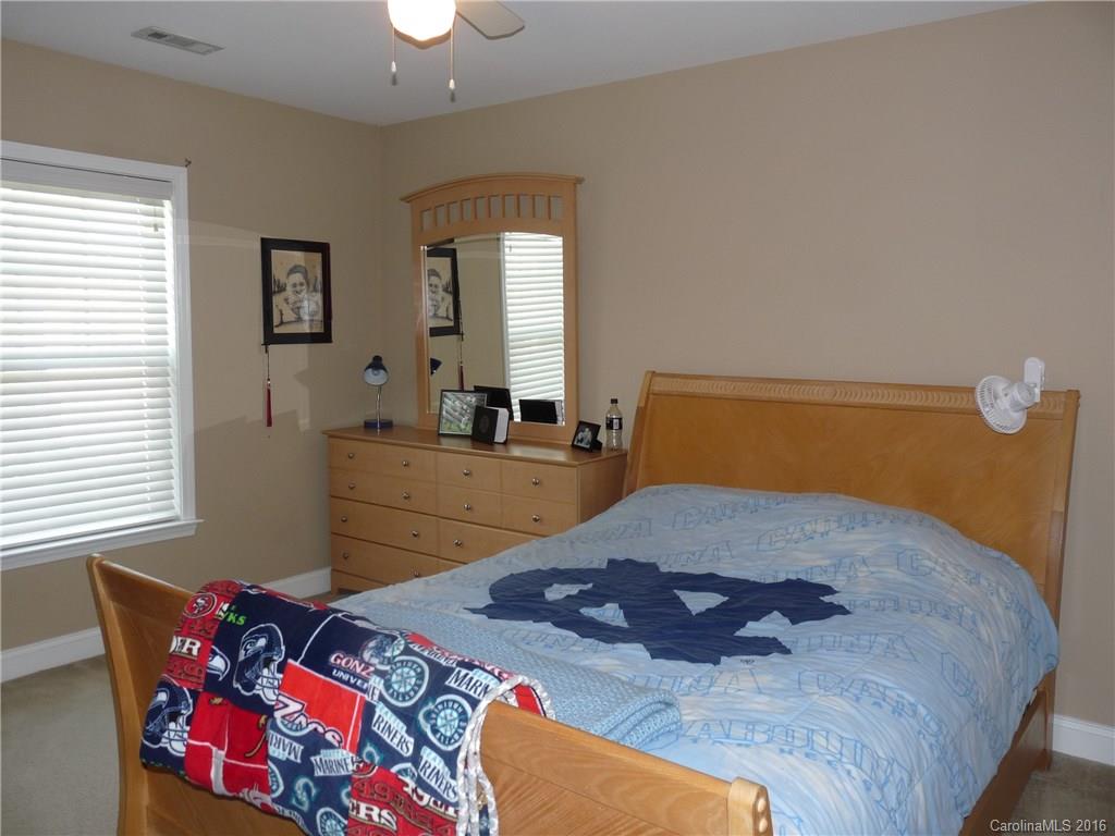 221 River Clay Road, Unit 183 Fort Mill, SC 29708 - Photo 13 of 20 a bed sitting in a bedroom next to a window