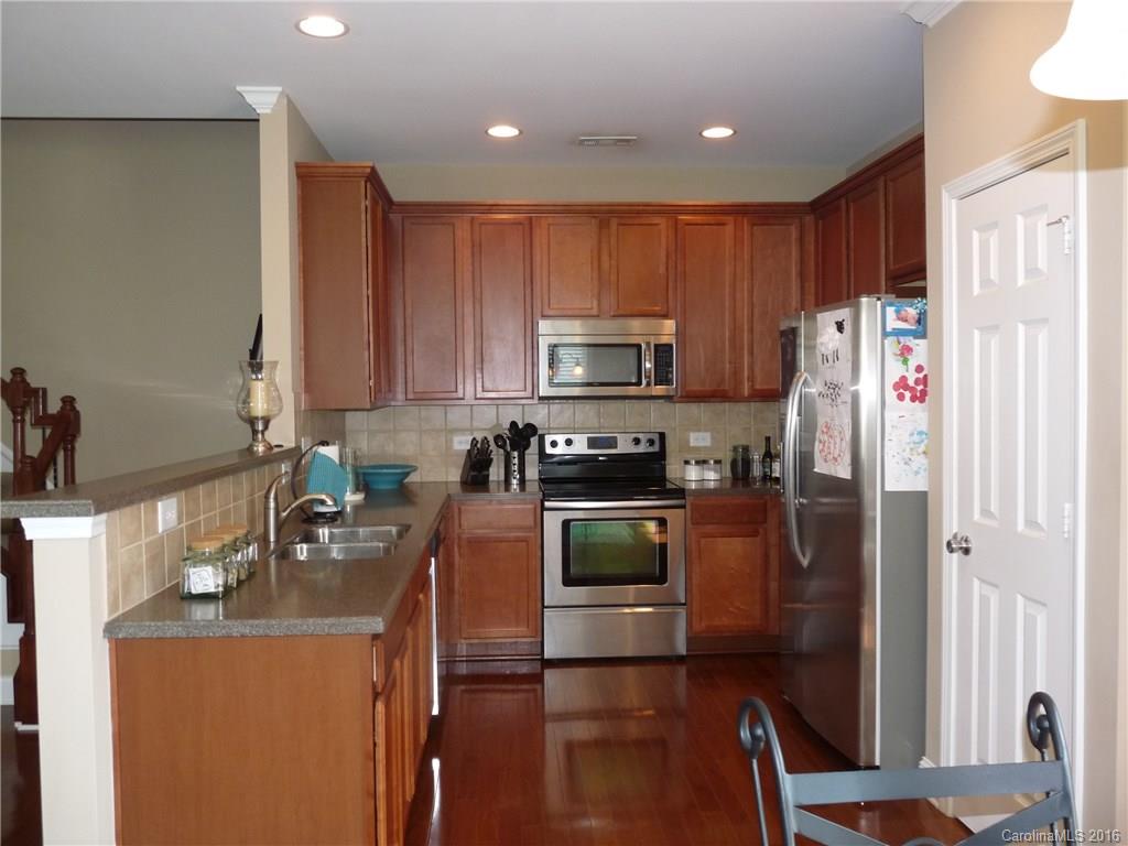 221 River Clay Road, Unit 183 Fort Mill, SC 29708 - Photo 5 of 20 a kitchen with stainless steel appliances granite countertop a refrigerator a stove top oven a sink and dishwasher