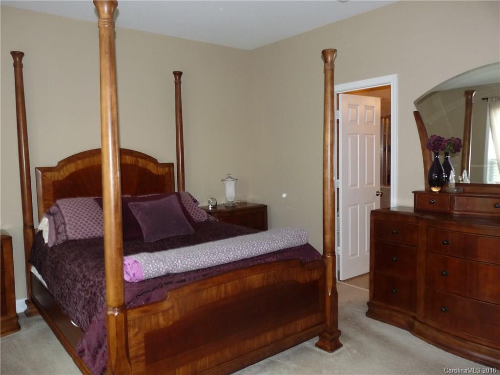 221 River Clay Road, Unit 183 Fort Mill, SC 29708 - Photo 8 of 20 a bedroom with a large bed and a mirror