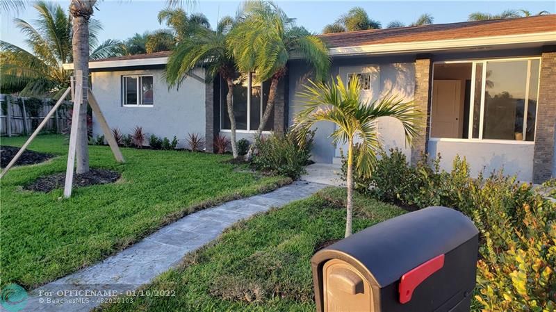 1721 Southwest 10th Street Boca Raton, FL 33486 - Photo 2 of 8 a view of house with a yard and potted plants