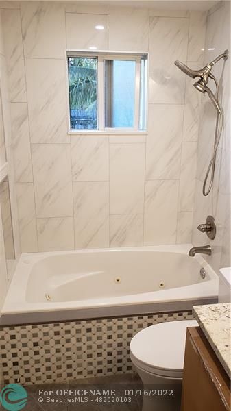 1721 Southwest 10th Street Boca Raton, FL 33486 - Photo 4 of 8 a bathroom with a bathtub and a shower