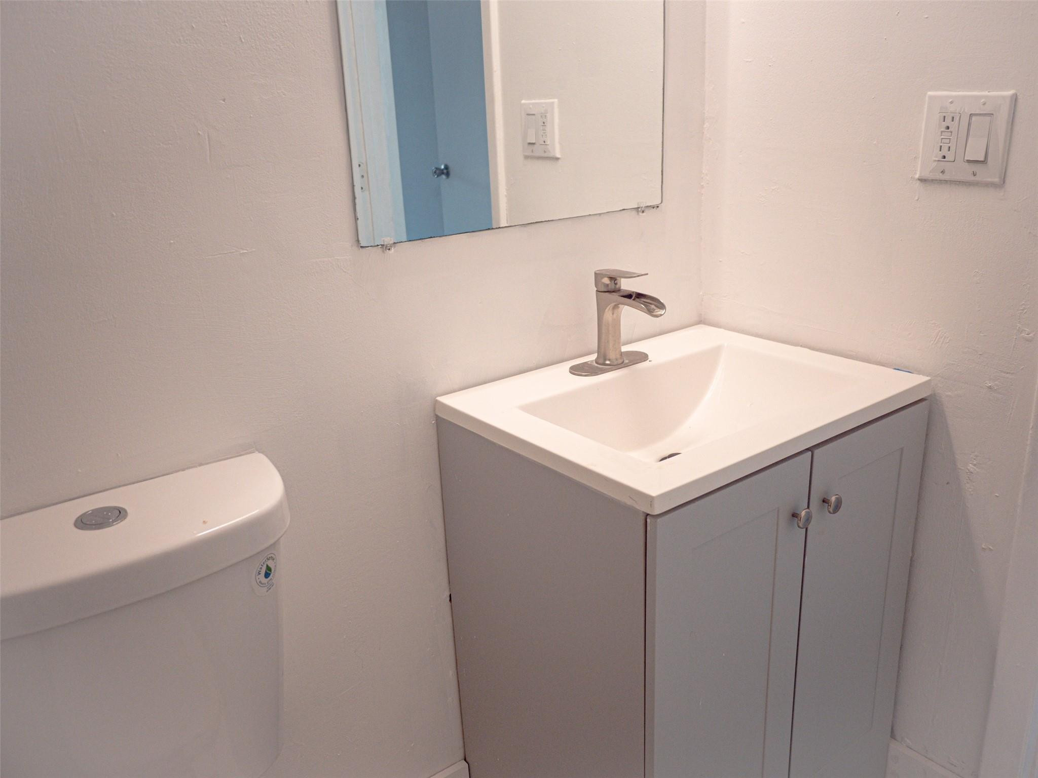 Undisclosed Address Tamarac, FL 33319 - Photo 16 of 21 a bathroom with a sink a vanity and a mirror