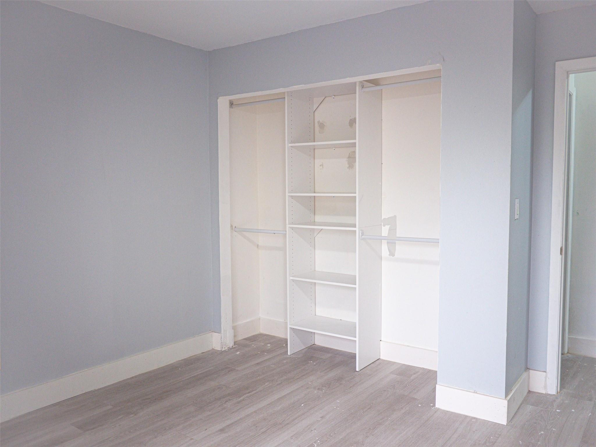 Undisclosed Address Tamarac, FL 33319 - Photo 18 of 21 a view of an empty room with wooden floor