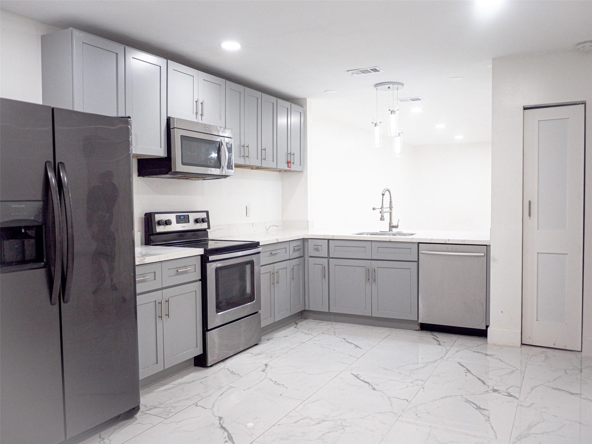 Undisclosed Address Tamarac, FL 33319 - Photo 4 of 21 a kitchen with a sink stainless steel appliances and cabinets