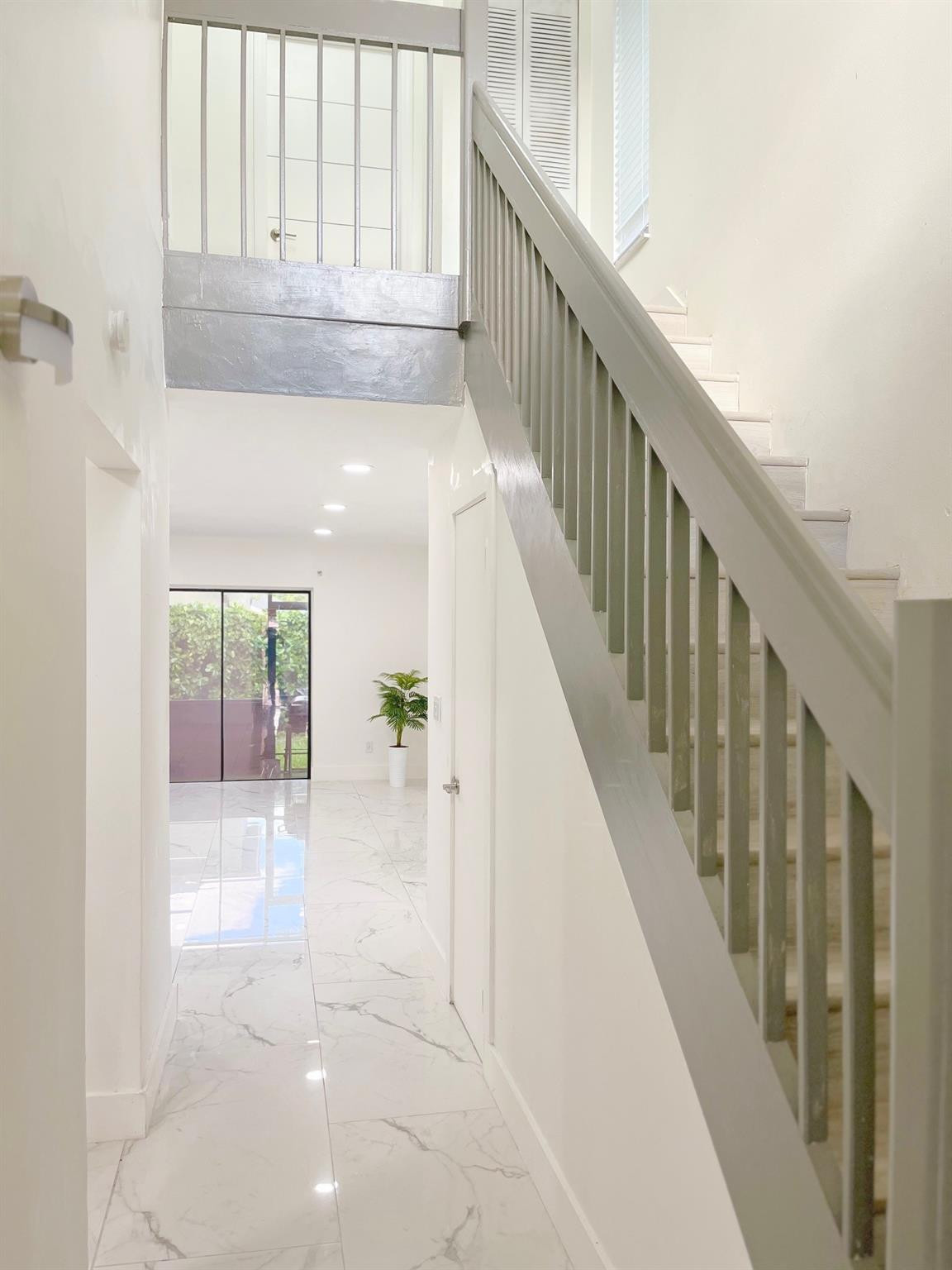Undisclosed Address Tamarac, FL 33319 - Photo 6 of 21 a view of staircase with white walls and windows