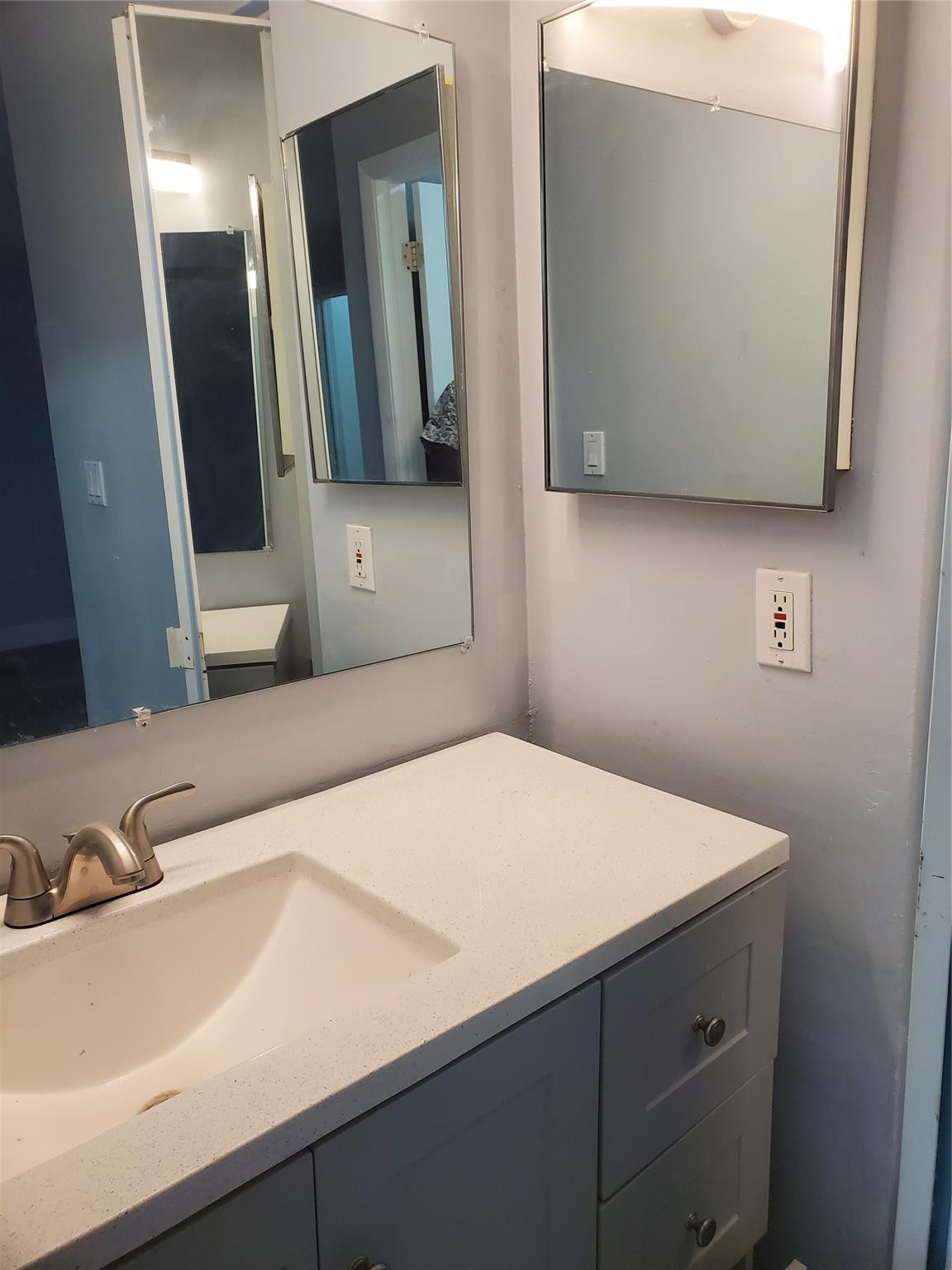 Undisclosed Address Tamarac, FL 33319 - Photo 7 of 21 a bathroom with a sink and a mirror