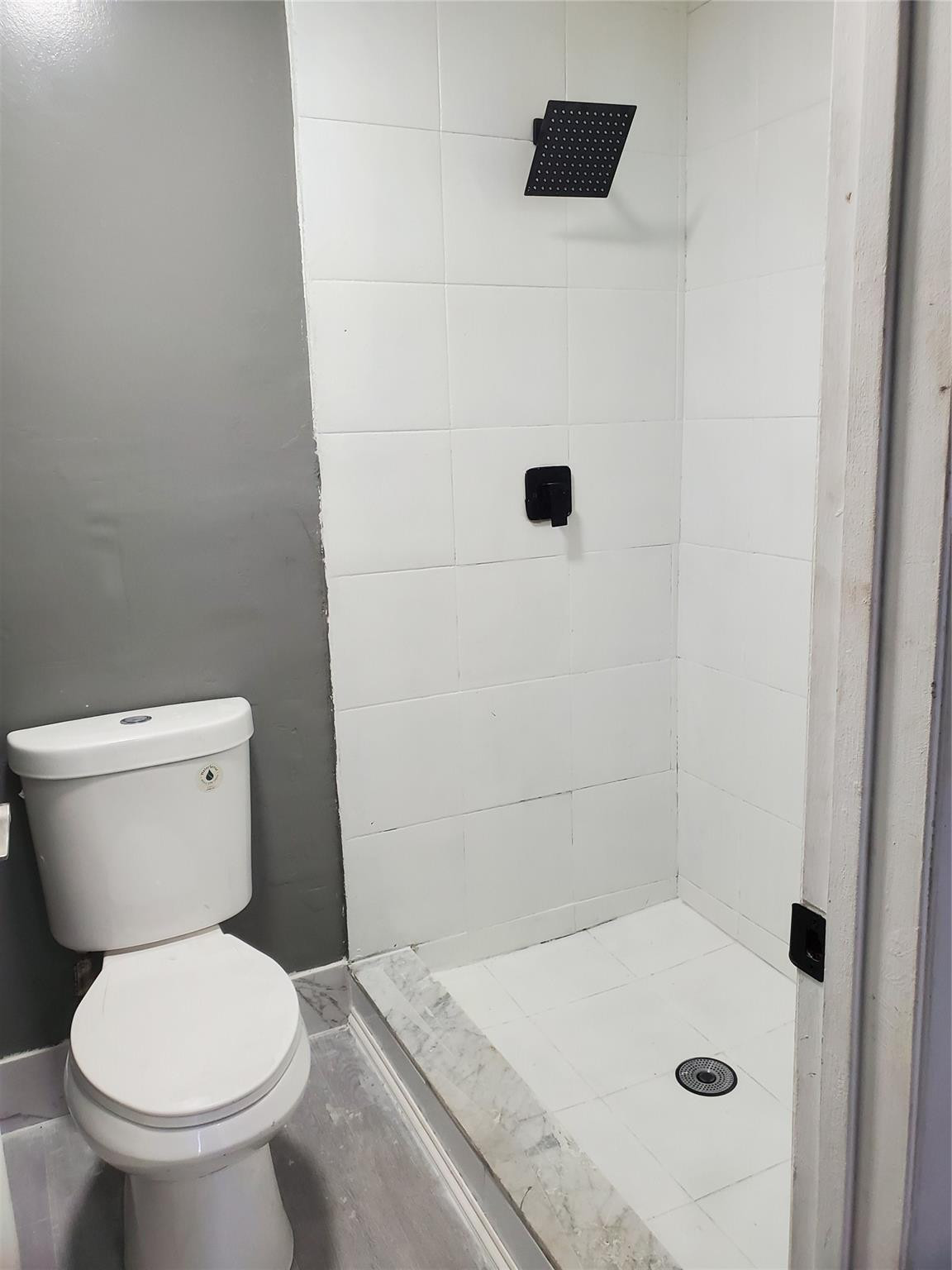 Undisclosed Address Tamarac, FL 33319 - Photo 9 of 21 a bathroom with a toilet and a shower