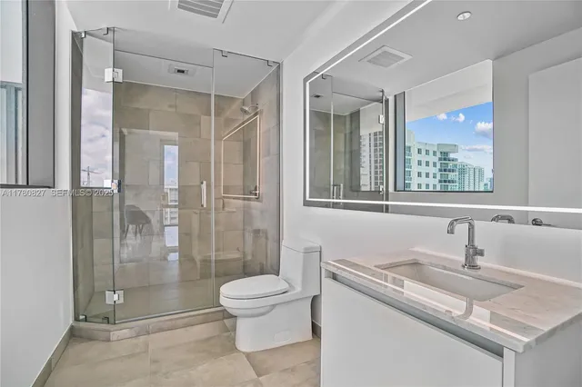 a bedroom with a large bed and a lamp next to a window