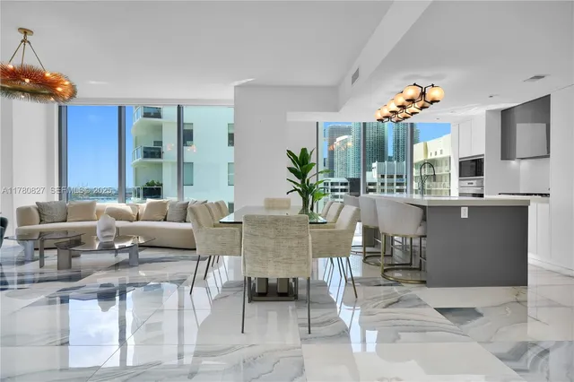 a living room with furniture potted plants and a chandelier