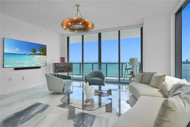 a living room with furniture and floor to ceiling window