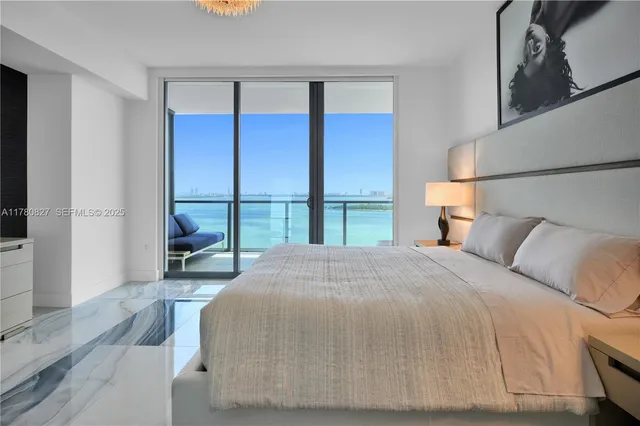 a bedroom with a large bed and a large window