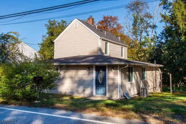a view of a house with wooden fence