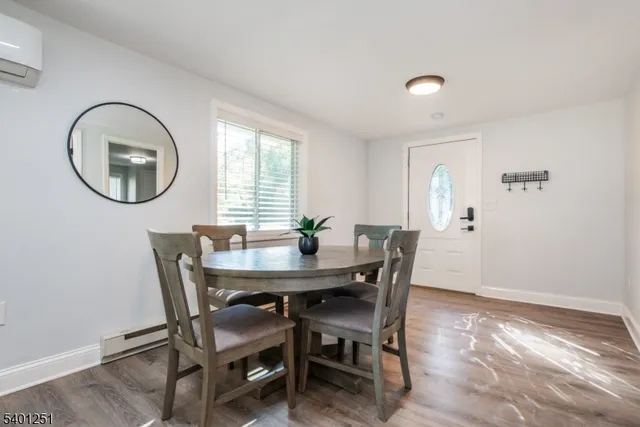 a view of a dining room with furniture and a mirror